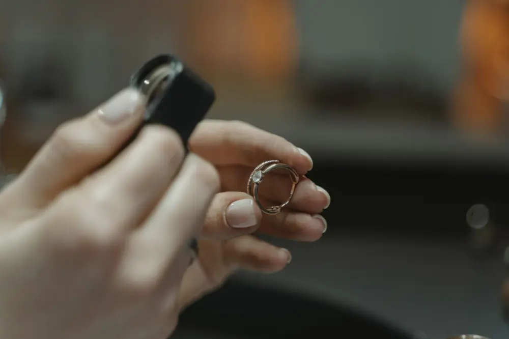 A diamond ring being checked under a jeweller's loupe